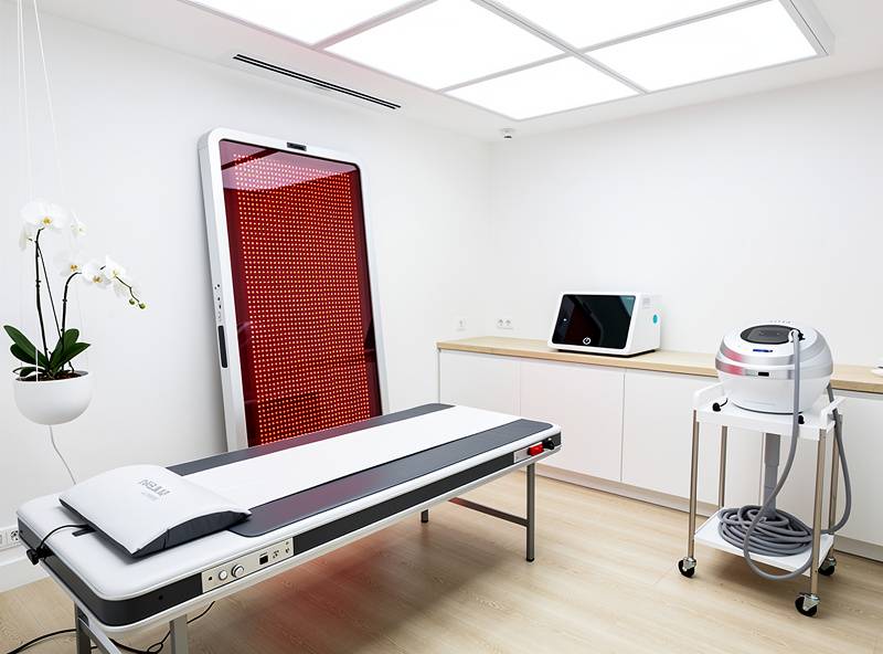 Representative biohacking recovery studio featuring PEMF treatment platform, red light therapy panel, and recovery technology equipment