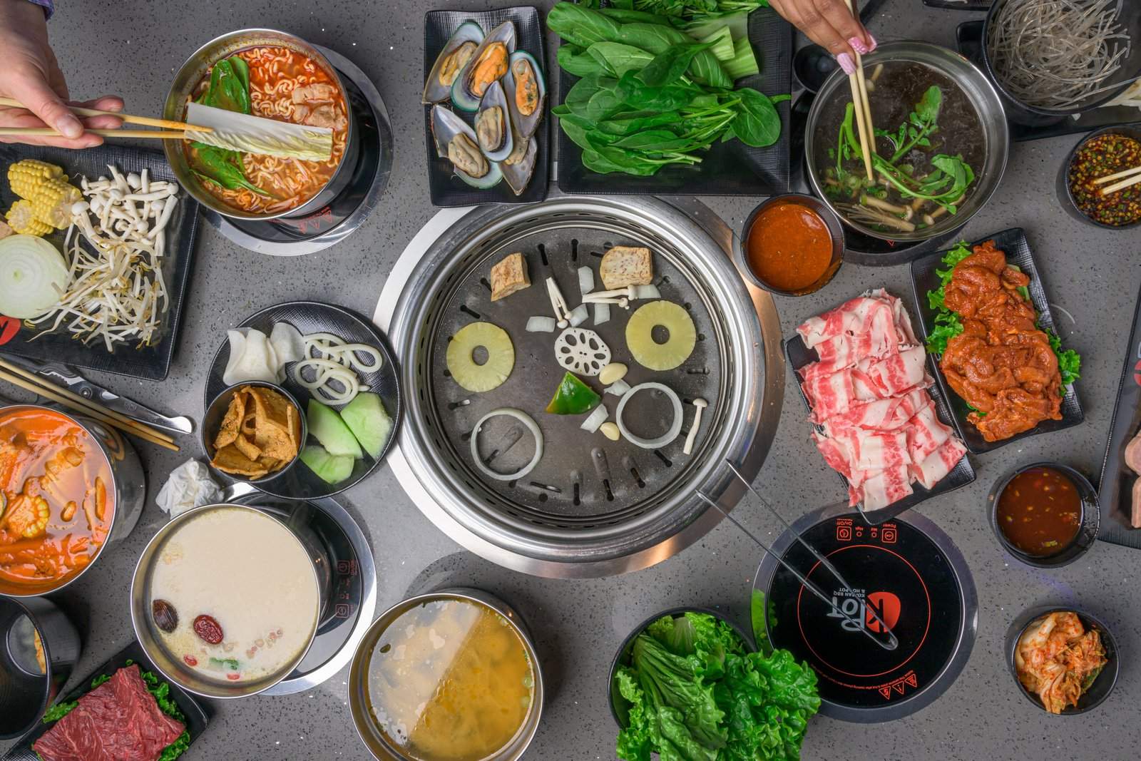 KPOT Korean BBQ & Hot Pot Pembroke Pines — all-you-can-eat Korean BBQ tables with grill and hot pot